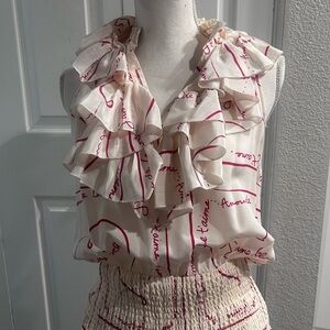 bebe Cream Ruffle Front Sleeveless Blouse with Red Script